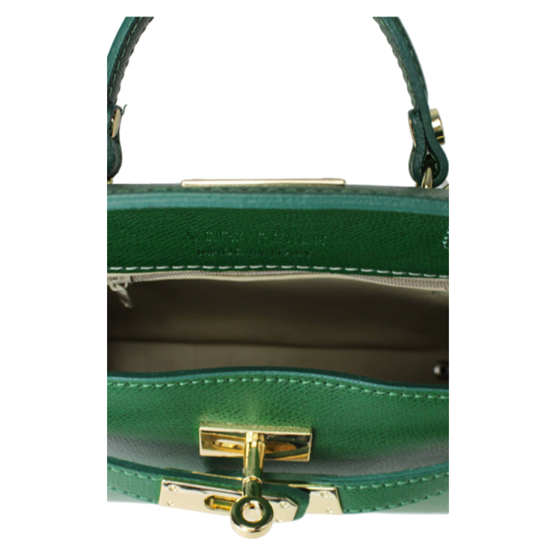 Inside view of green leather small tote bag with gold clasp and lining.
