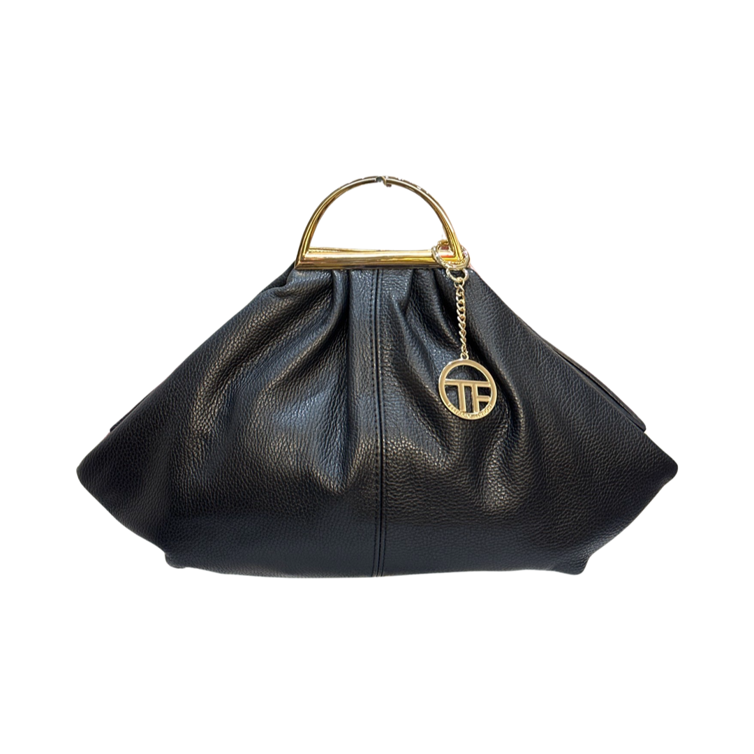 Leather tote bag with tassels, double handles, and adjustable shoulder strap.