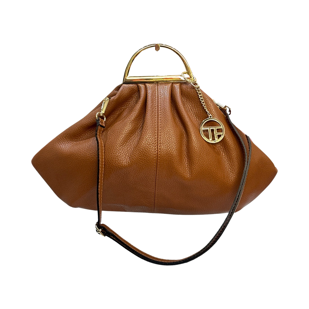 Leather tote bag with tassels, double handles, and adjustable shoulder straps.