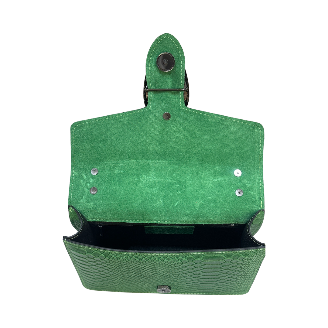 Crossbody leather bag with chain strap, green interior, and push-button clasp.