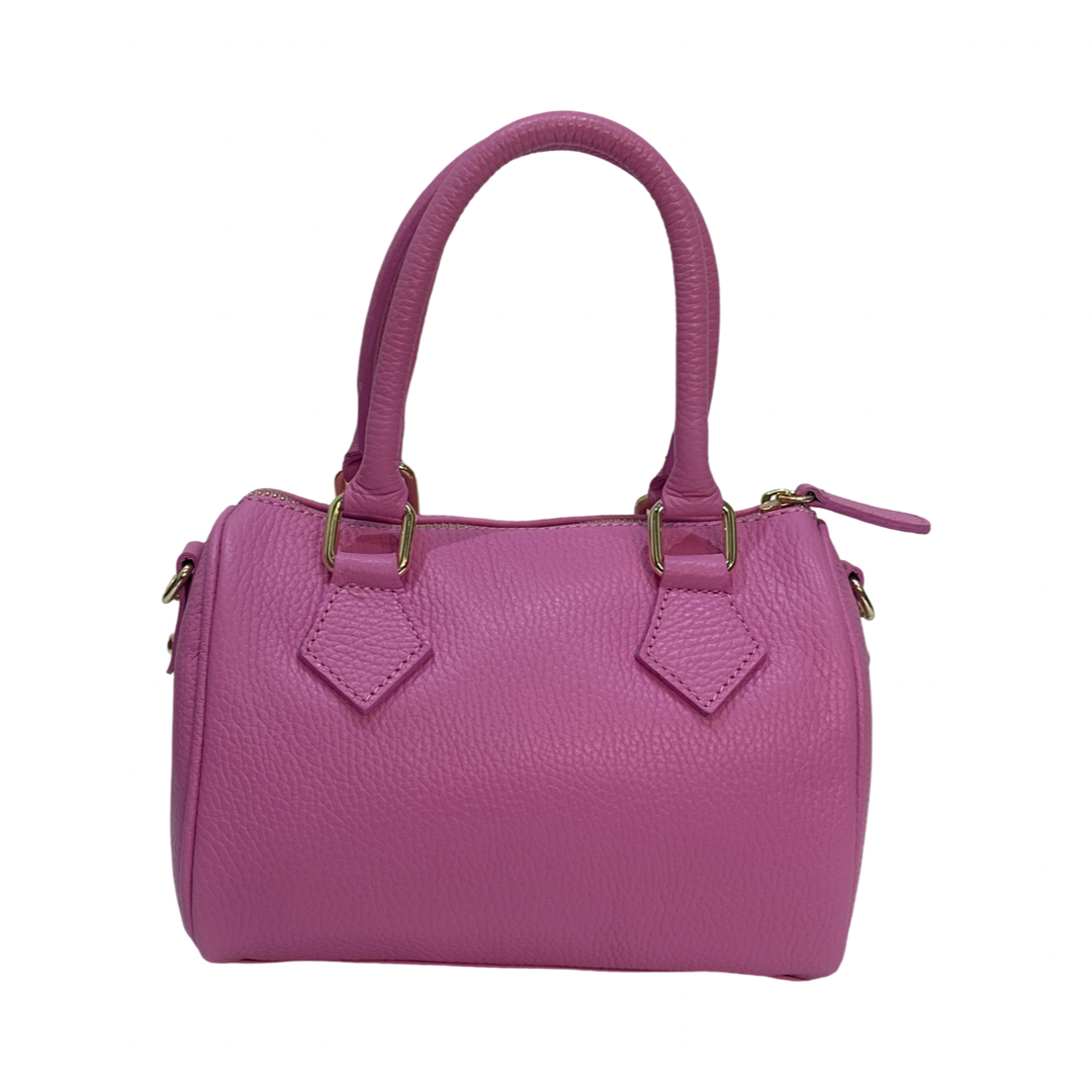 Pink leather tote bag side view showing gold details and strap rings.
