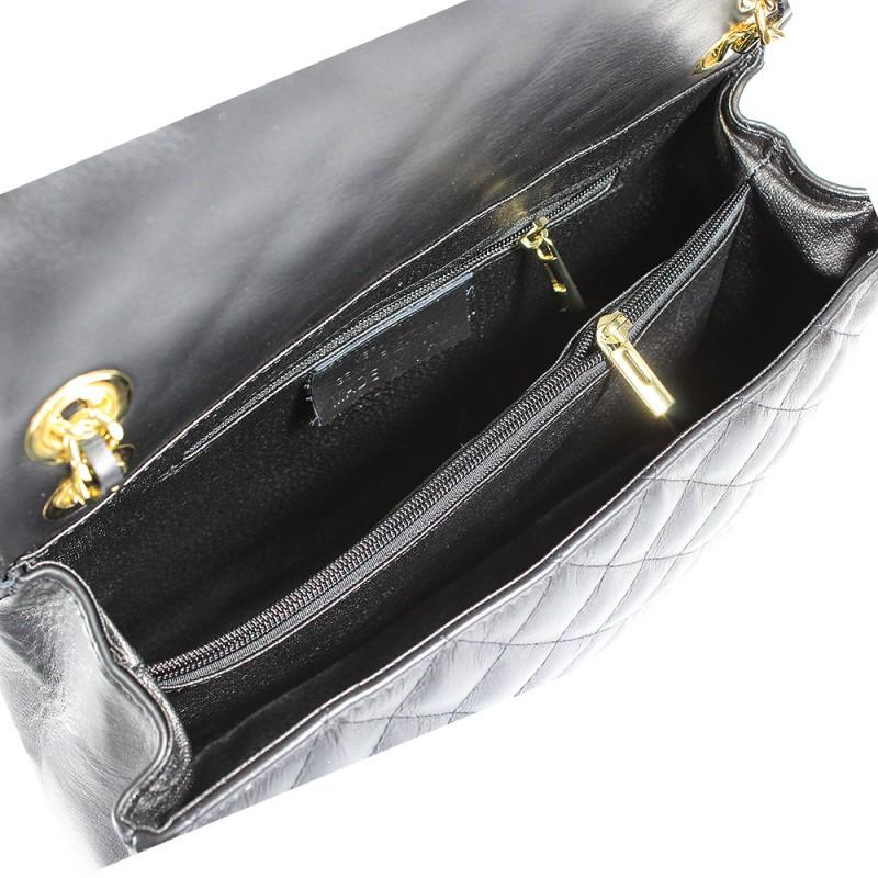 Quilted oversized chain shoulder bag with spacious interior and gold-tone turn-lock closure.