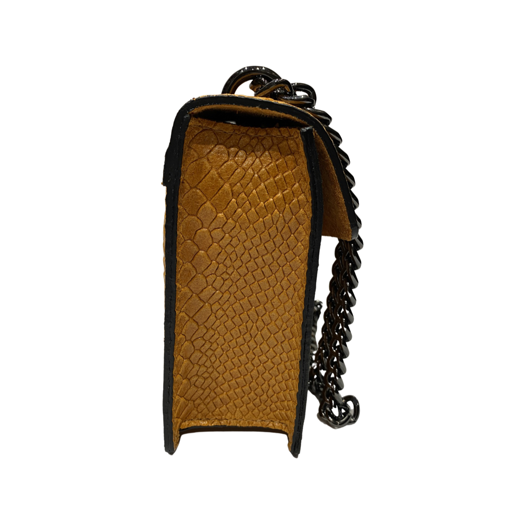 Side view of a small crossbody leather bag with chain strap and textured calf leather.