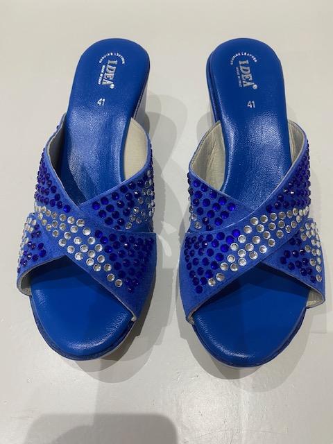 Blue platform wedge sandals with rhinestones and bow tie design.