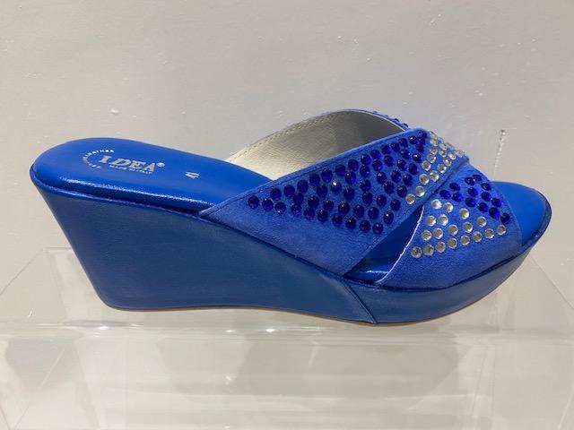 Blue platform wedge heel sandals with rhinestone detailing and bow tie design.