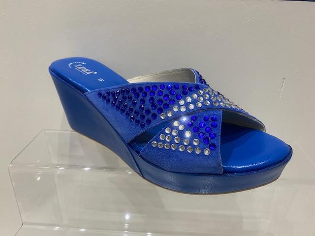 Blue platform wedge heel sandals with bow tie rhinestone embellishments, open-toe slip-on design.