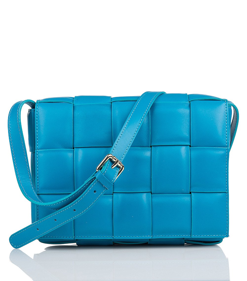 Luxurious padded blue leather tote bag with adjustable strap, crafted by Italian artisans.