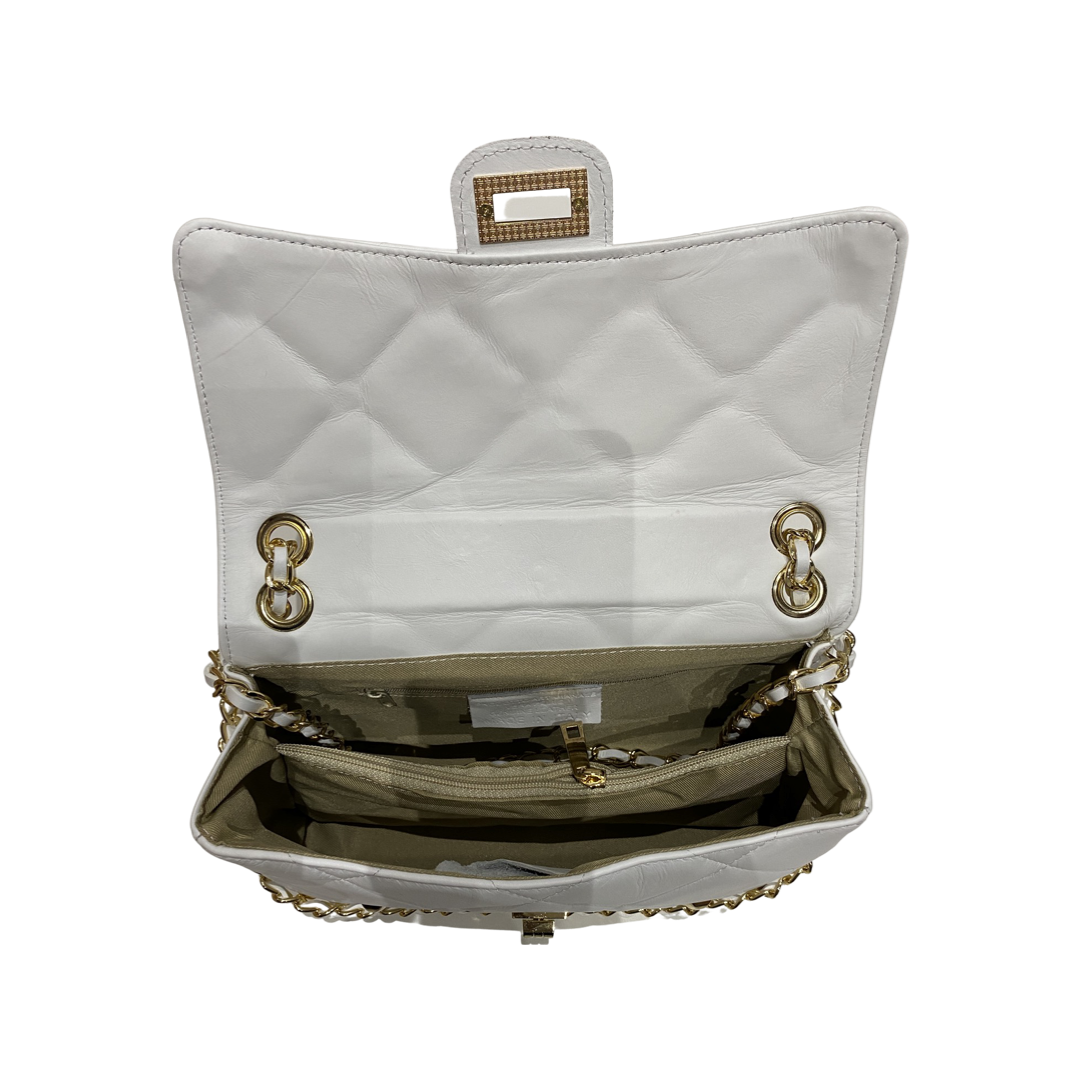 Quilted crossbody leather bag with chain strap and compartments.