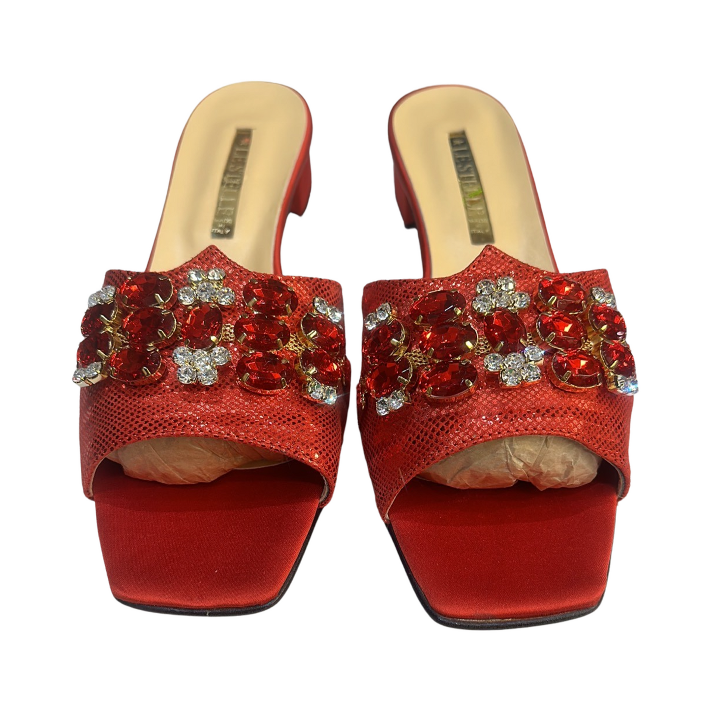 Red rhinestone flat mules with embellishments, trendy summer footwear.