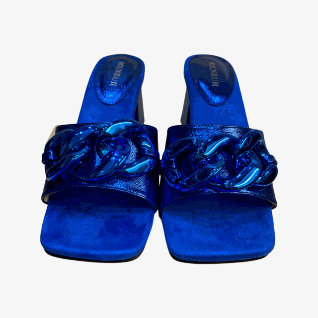 Glamorous blue block heel mules with chain embellishments and square toe design.