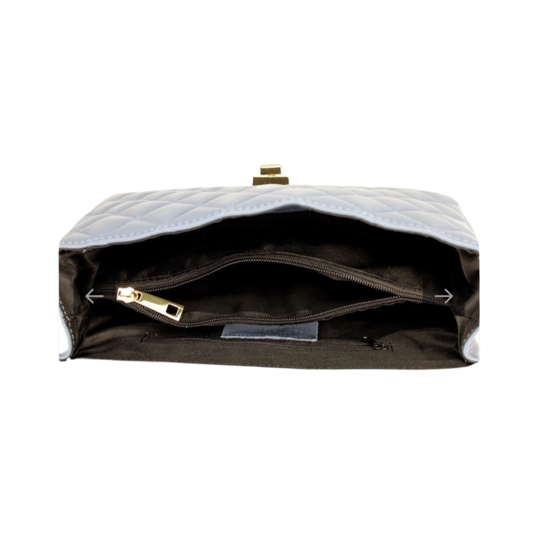 Open view of a quilted chain shoulder bag with spacious interior and secure turn-lock closure.
