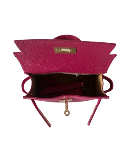 Open pink leather mini handbag showing interior and shoulder strap