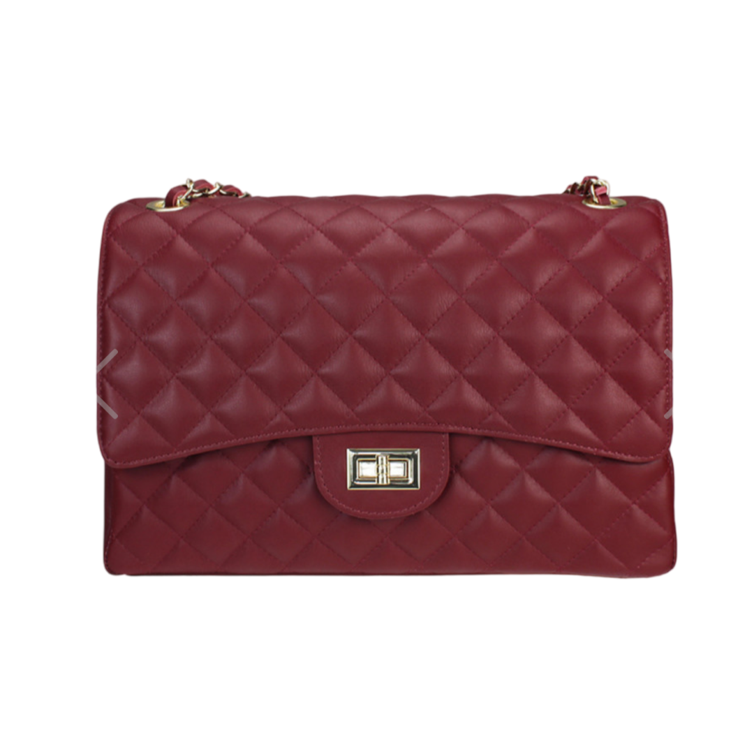 Luxurious quilted oversized chain shoulder bag with diamond stitching and gold-tone strap.
