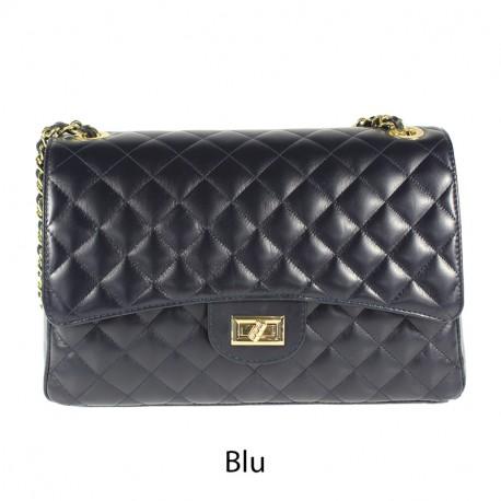 Quilted oversized chain shoulder bag in blue with gold-tone chain strap and turn-lock closure.